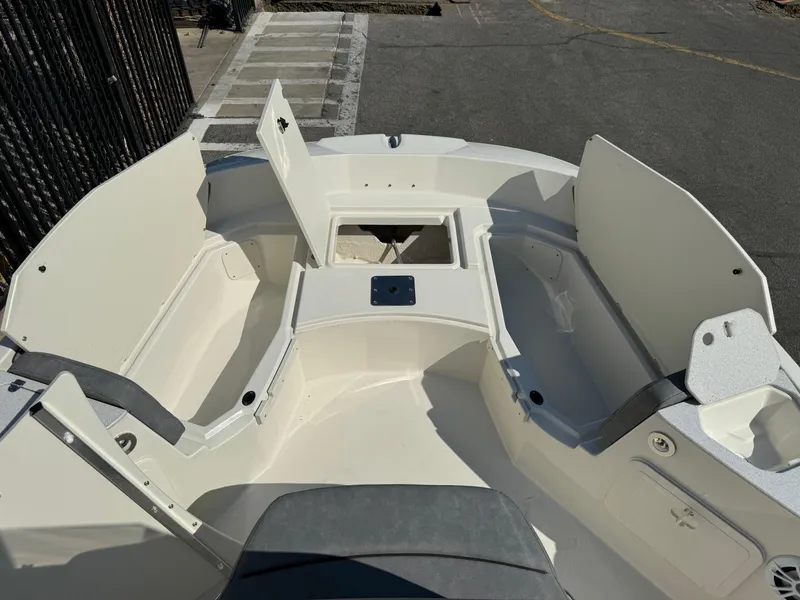 Slide: The Image of 2022 Stingray 206 CC boat interior with storage compartments and speaker. - 10