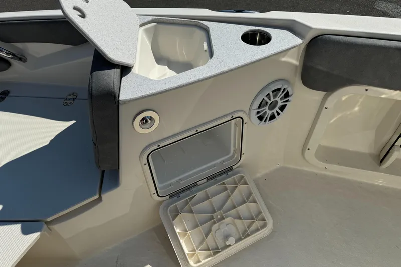 Slide: The Image of 2022 Stingray 206 CC boat interior with cushioned seating and storage compartments. - 11