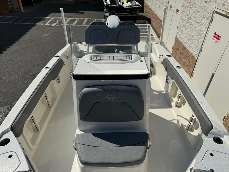 Slide: The Image of 2022 Stingray 206 CC boat interior with cushioned seating and console. - 13