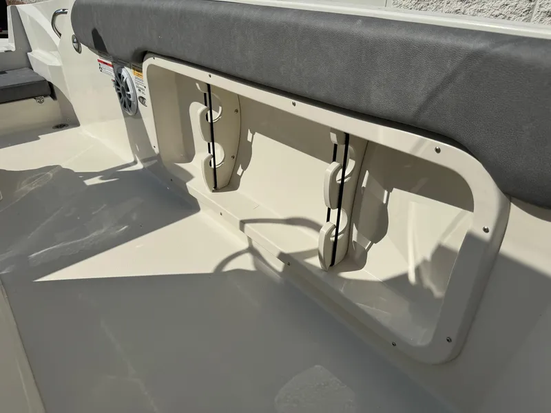 Slide: The Image of 2022 Stingray 206 CC boat interior with Garmin navigation system and open cabin door. - 15