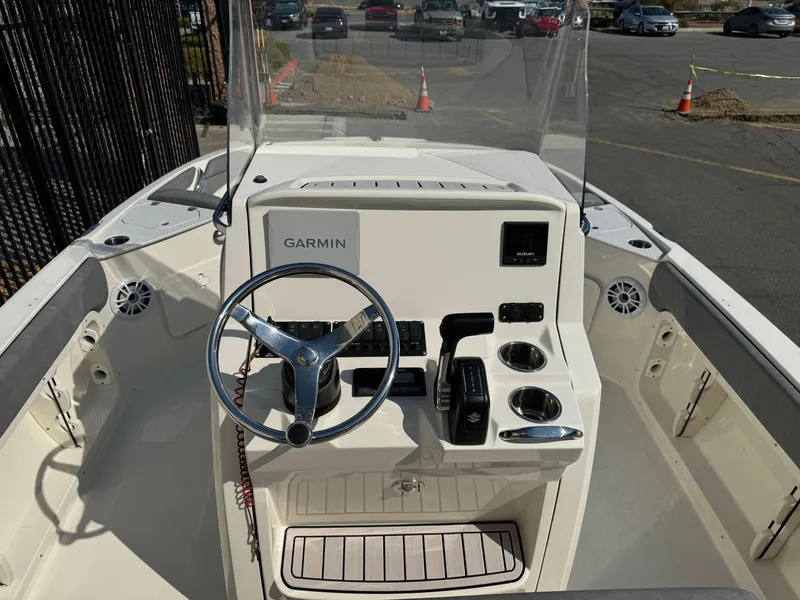 Slide: The Image of 2022 Stingray 206 CC boat dashboard with Garmin navigation system and steering wheel. - 17