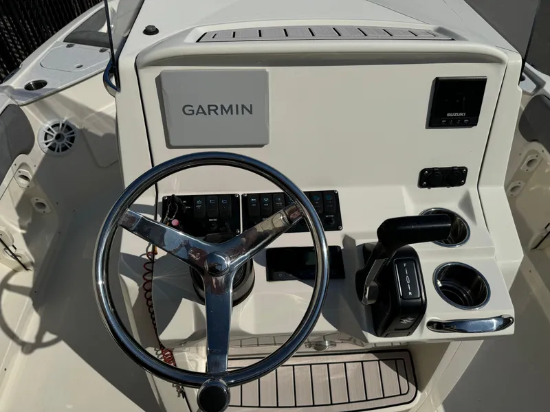 Slide: The Image of 2022 Stingray 206 CC boat interior with dual seats and steering wheel. - 18