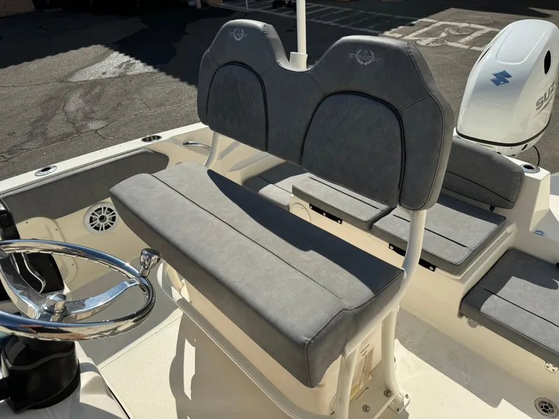 Slide: The Image of 2022 Stingray 206 CC boat with Suzuki outboard motor and cushioned seating. - 19