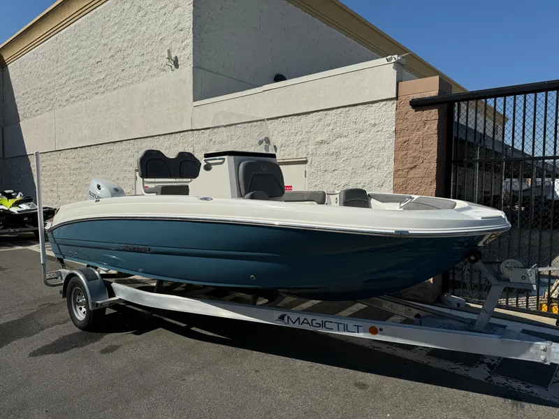 Slide: The Image of 2022 Stingray 206 CC boat on a trailer in a parking lot. - 2
