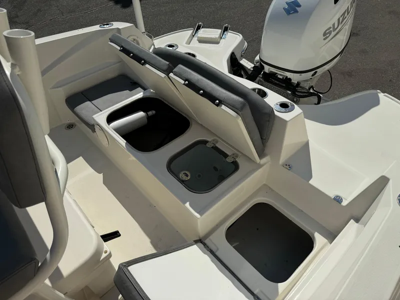 Slide: The Image of 2022 Stingray 206 CC boat interior with steering wheel and rod holders. - 21
