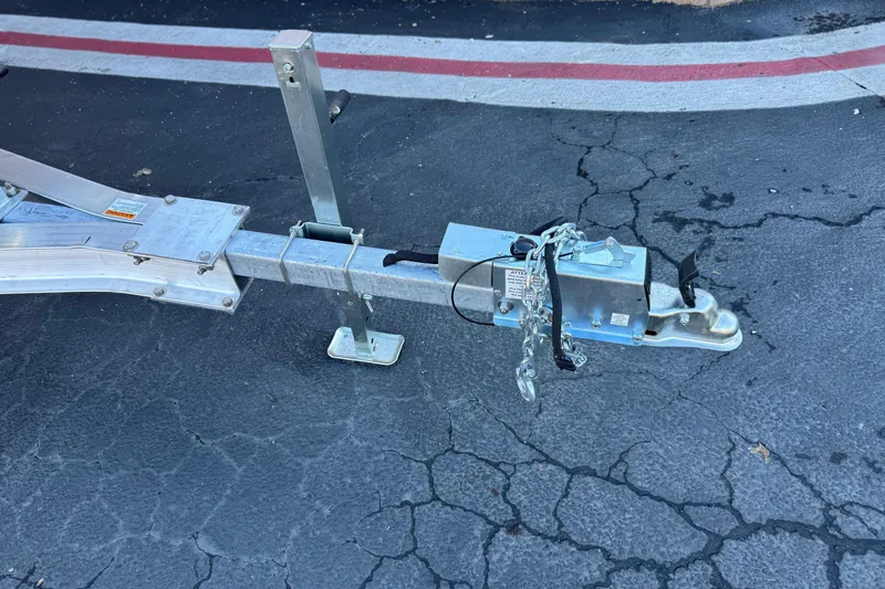 Slide: The Image of Trailer hitch of a 2022 Stingray 206 CC on cracked asphalt surface. - 25