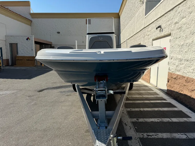 Slide: The Image of 2022 Stingray 206 CC boat, front view, white exterior, parked outdoors. - 3