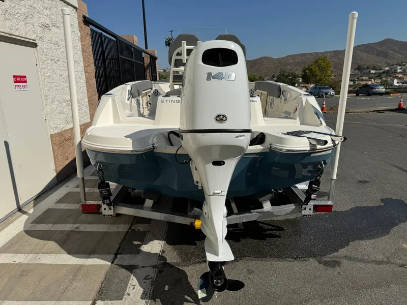 Slide: The Image of 2022 Stingray 206 CC boat with Suzuki outboard motor on trailer. - 7