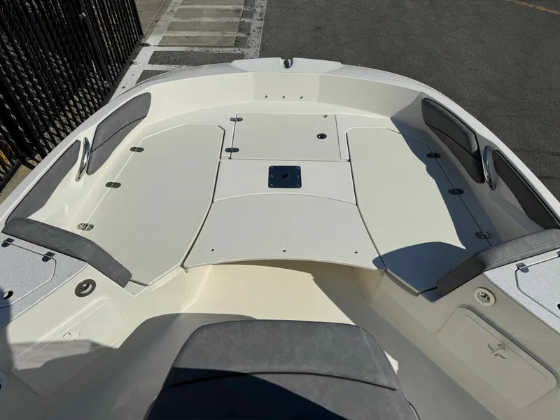 Slide: The Image of 2022 Stingray 206 CC boat interior with open storage compartments. - 9