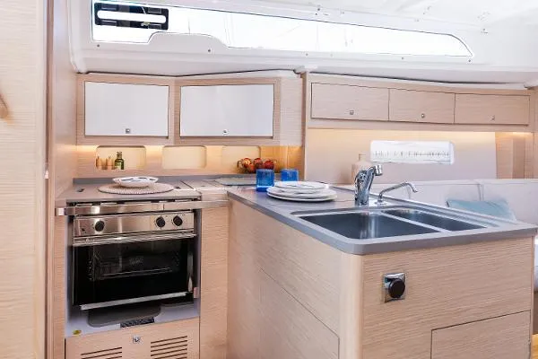 Slide: The Image of Modern kitchen in 2024 Dufour 37 yacht with stove, sink, and cabinets. - 3