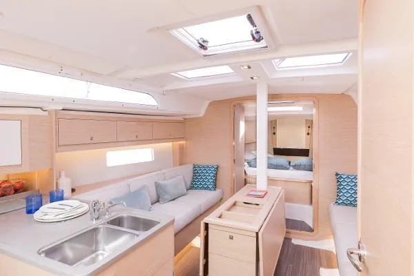 Slide: The Image of Modern interior of 2024 Dufour 37 sailboat with cozy seating and kitchen area. - 4