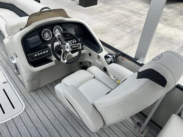 Slide: The Image of 2018 Avalon Catalina Funship 27' boat cockpit with steering wheel and captain's chair. - 13