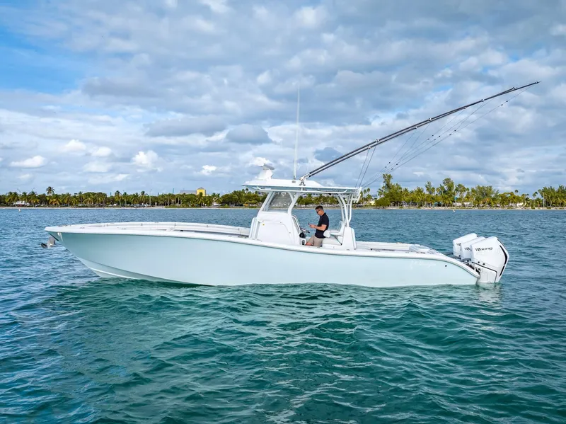 Slide: The Image of 2023 Yellowfin 36 boat cruising on a calm sea under a partly cloudy sky. - 10