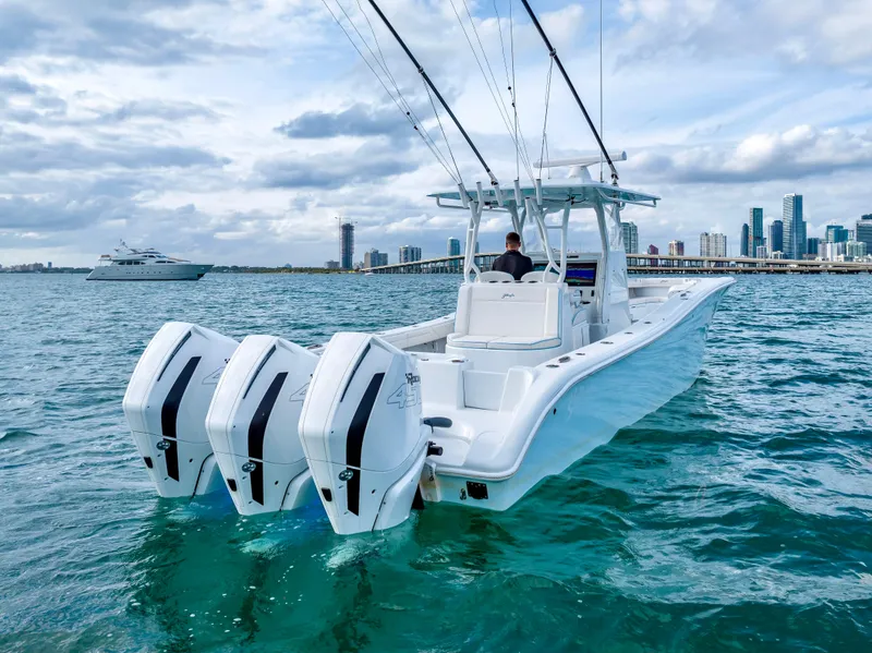 Slide: The Image of 2023 Yellowfin 36 boat with triple outboard engines on the water. - 13
