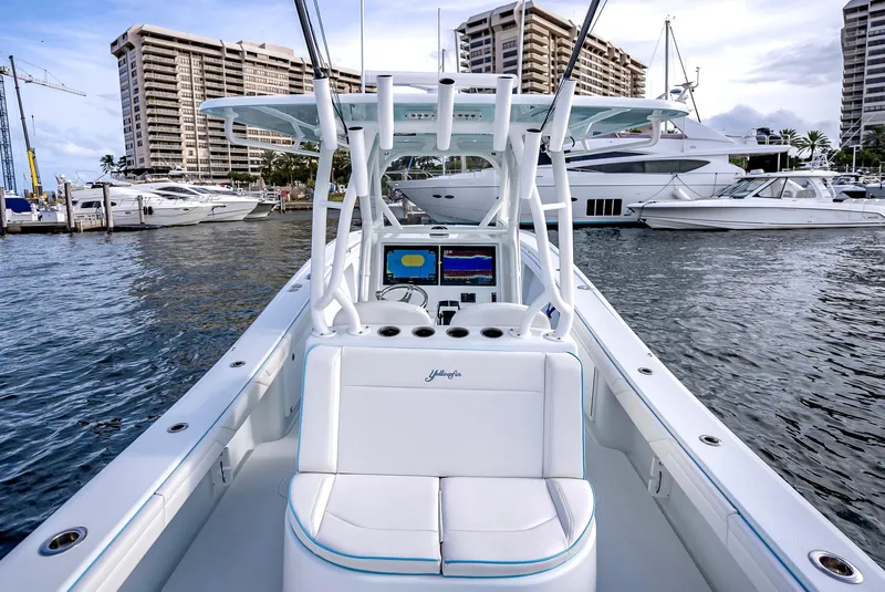 Slide: The Image of 2023 Yellowfin 36 boat docked in a marina with luxury yachts. - 28