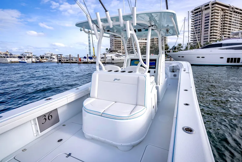 Slide: The Image of 2023 Yellowfin 36 boat docked at marina with luxury yachts in background. - 31
