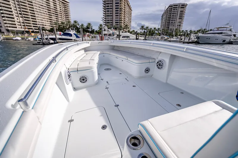 Slide: The Image of 2023 Yellowfin 36 boat with spacious deck and seating, docked in a marina. - 32