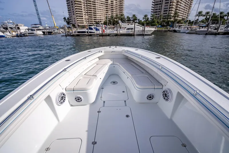 Slide: The Image of 2023 Yellowfin 36 boat bow with seating and speakers, docked in a marina. - 34