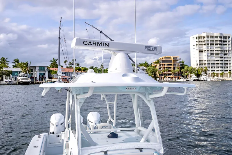 Slide: The Image of 2023 Yellowfin 36 boat with Garmin radar on water near waterfront buildings. - 45