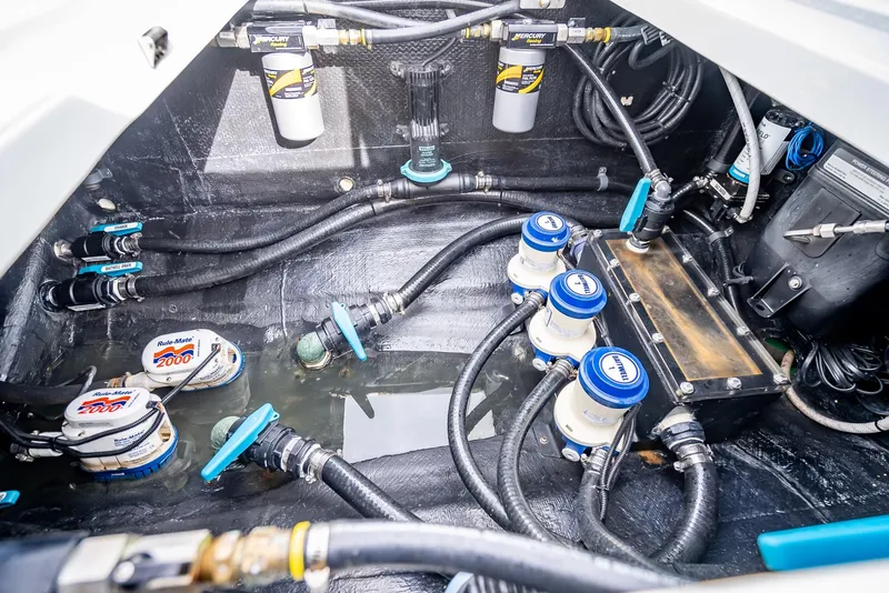 Slide: The Image of Engine compartment of a 2023 Yellowfin 36 boat with various mechanical components. - 49