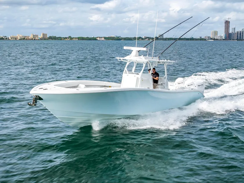 Slide: The Image of 2023 Yellowfin 36 boat cruising on open water with fishing rods. - 6