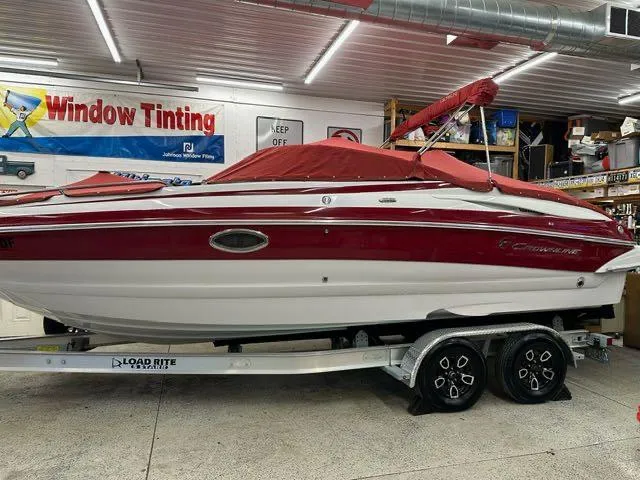 Slide: The Image of 2011 Crownline BOWRIDER 245 SS boat on a Load Rite trailer in a garage. - 1