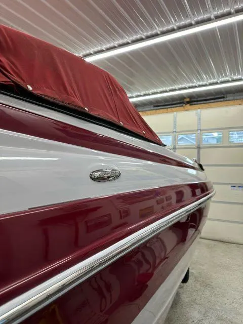 Slide: The Image of 2011 Crownline BOWRIDER 245 SS in a garage with red and white exterior. - 13