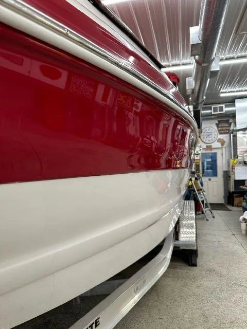 Slide: The Image of 2011 Crownline BOWRIDER 245 SS in a garage, red and white exterior. - 15