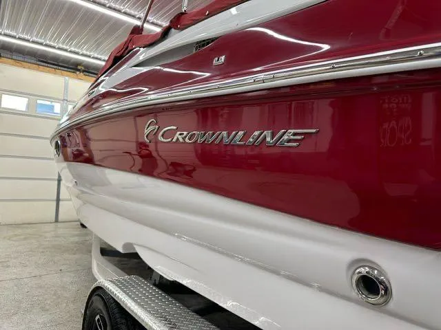 Slide: The Image of 2011 Crownline BOWRIDER 245 SS in a garage, red and white exterior. - 17