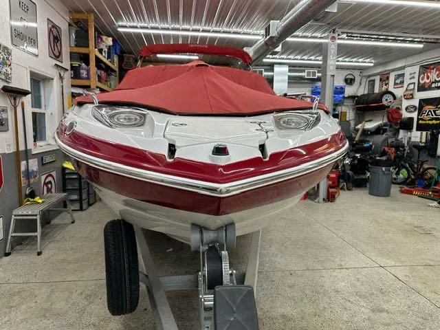 Slide: The Image of 2011 Crownline BOWRIDER 245 SS in a garage, covered with a red tarp. - 3