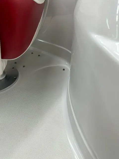 Slide: The Image of Interior detail of a 2011 Crownline BOWRIDER 245 SS boat with red seating. - 6