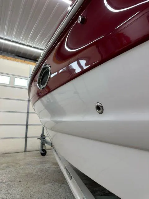 Slide: The Image of 2011 Crownline BOWRIDER 245 SS in a garage, close-up side view. - 9
