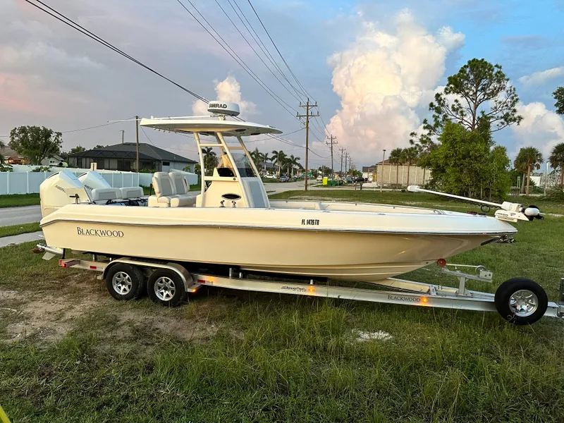 The Image of 2023 Blackwood 27HD boat on a trailer, parked on grass. - 0