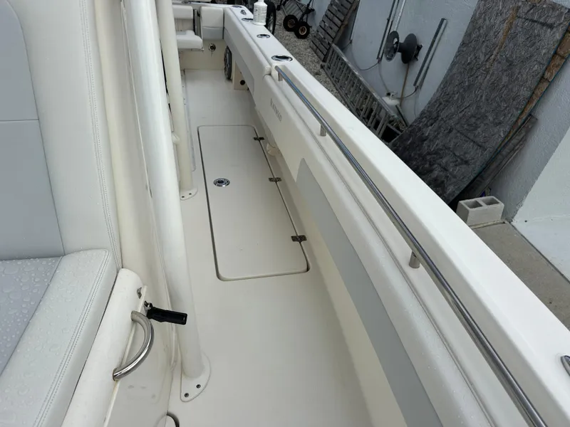 Slide: The Image of 2023 Blackwood 27HD boat interior with sleek white seating and storage compartments. - 31