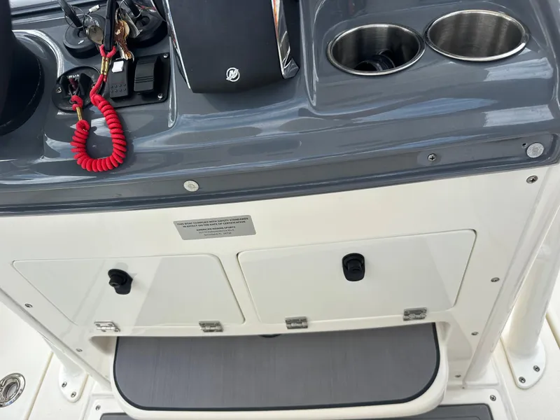 Slide: The Image of Control panel of 2023 Blackwood 27HD boat with cup holders and storage compartments. - 35