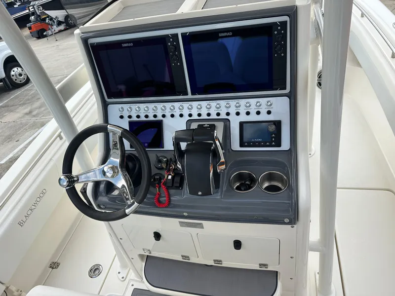 Slide: The Image of 2023 Blackwood 27HD boat console with dual Simrad displays and steering wheel. - 39