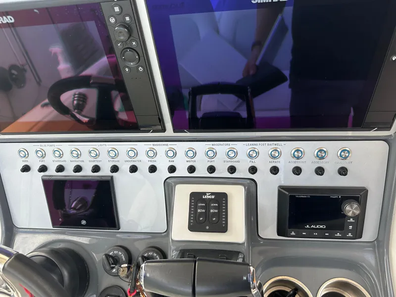 Slide: The Image of Control panel of 2023 Blackwood 27HD boat with multiple screens and switches. - 48