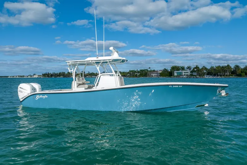 The Image of 2025 Yellowfin 32 boat on clear blue water under a partly cloudy sky. - 0