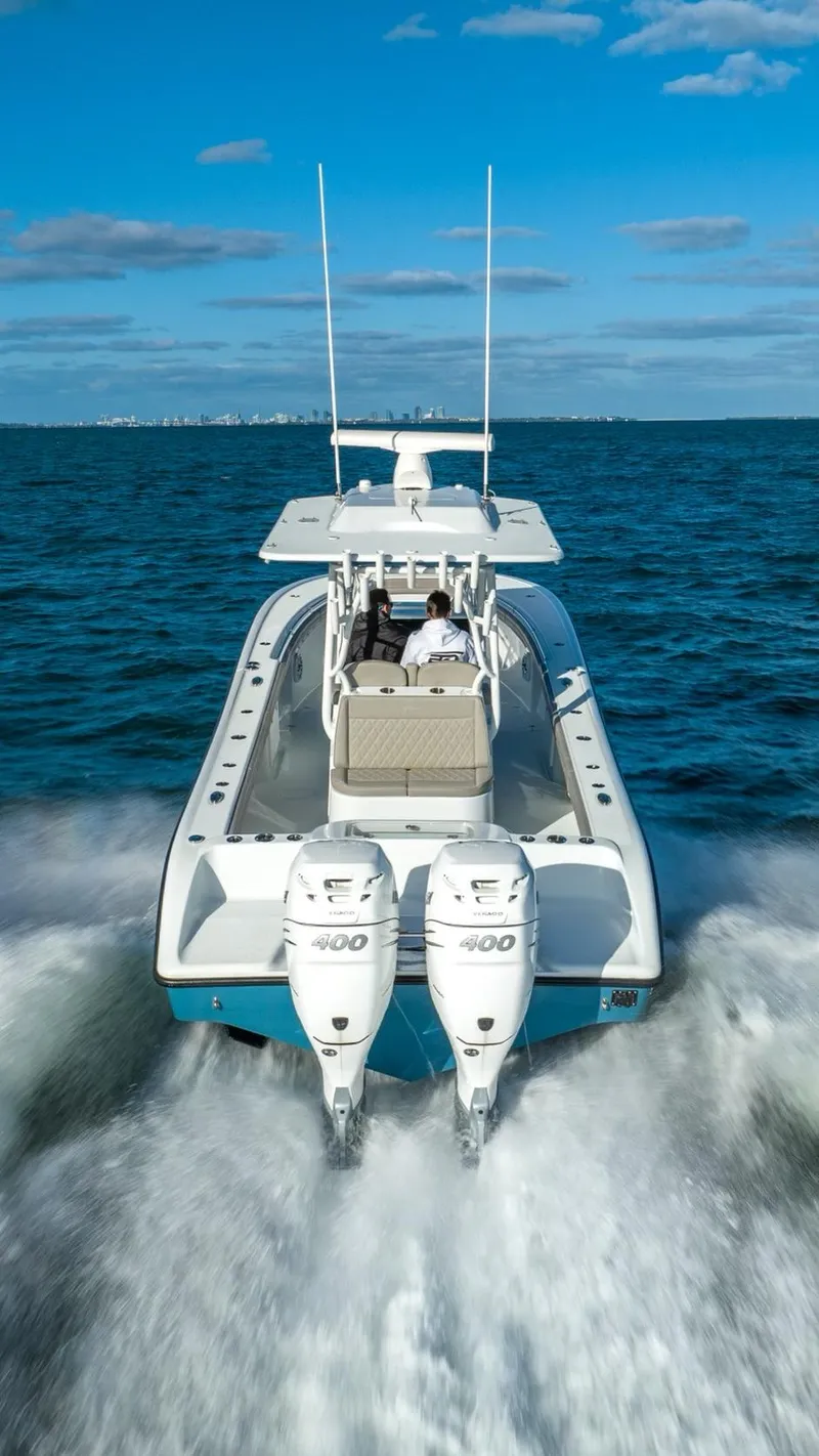 Slide: The Image of 2025 Yellowfin 32 boat cruising on open water with twin 400 engines. - 13
