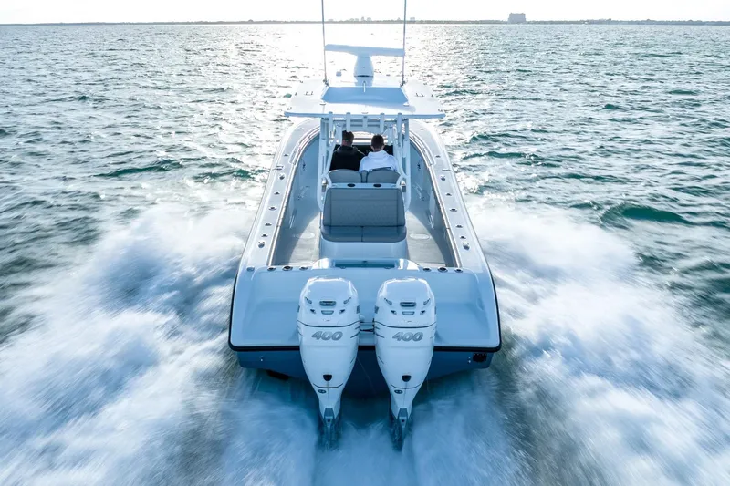 Slide: The Image of 2025 Yellowfin 32 boat with twin 400 engines cruising on open water. - 15