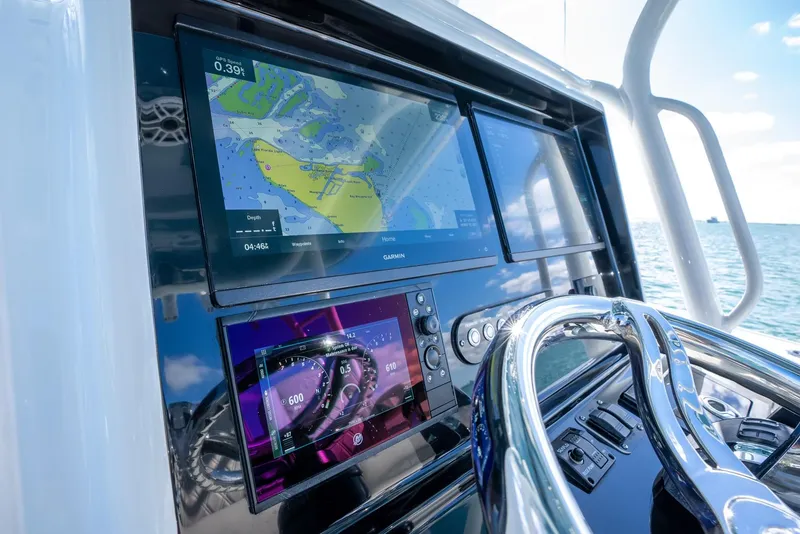 Slide: The Image of 2025 Yellowfin 32 boat dashboard with navigation screens and steering wheel. - 17