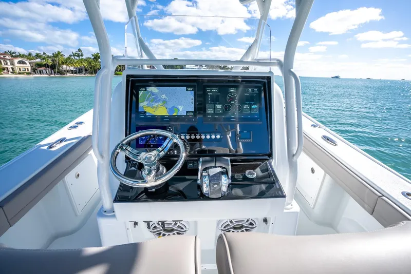 Slide: The Image of 2025 Yellowfin 32 boat dashboard with advanced navigation system on a sunny day. - 19