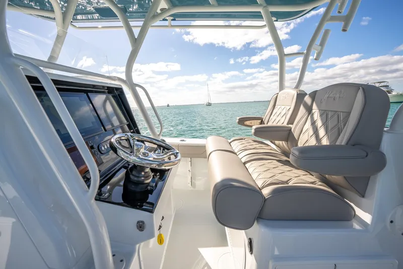Slide: The Image of 2025 Yellowfin 32 boat interior with modern helm and comfortable seating. - 21