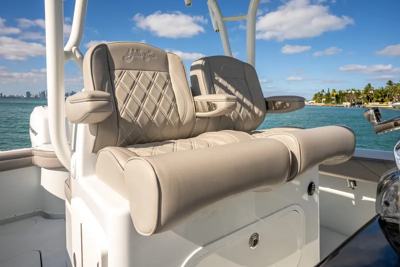 Slide: The Image of Luxury seating on a 2025 Yellowfin 32 boat with ocean backdrop. - 22