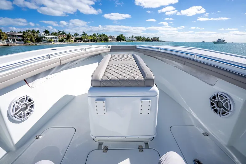 Slide: The Image of 2025 Yellowfin 32 boat interior with cushioned seating and ocean view. - 24