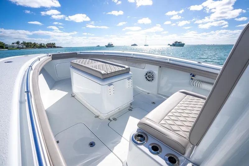 Slide: The Image of 2025 Yellowfin 32 boat interior with cushioned seating and ocean view. - 26