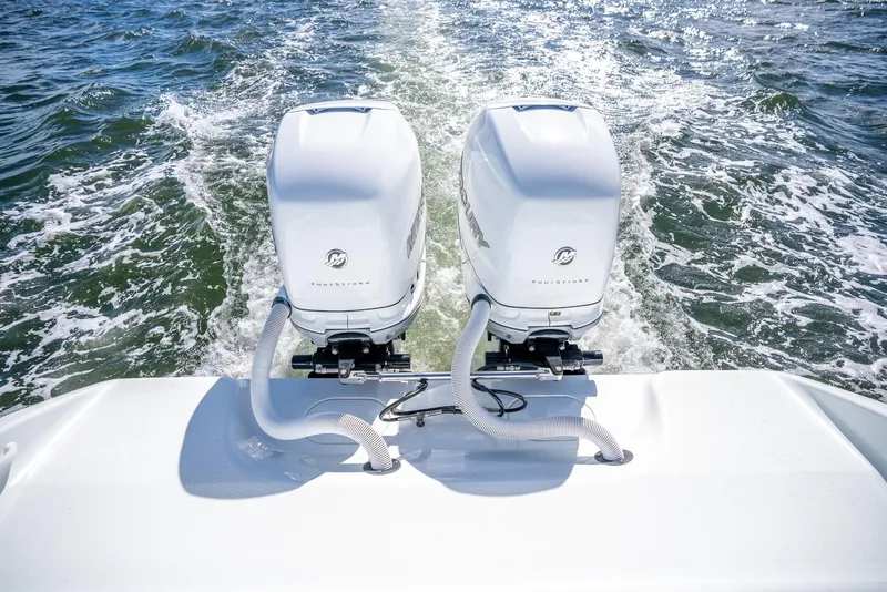 Slide: The Image of Twin outboard motors on a 2025 Yellowfin 32 boat in the water. - 34