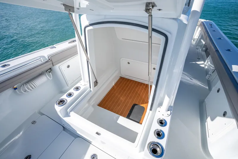 Slide: The Image of 2025 Yellowfin 32 boat interior storage compartment with wooden flooring. - 40