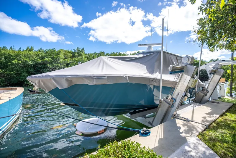 Slide: The Image of 2025 Yellowfin 32 boat docked with cover on a sunny day. - 43