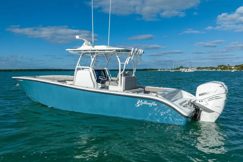 Slide: The Image of 2025 Yellowfin 32 boat on clear blue water with Mercury outboard engine. - 5